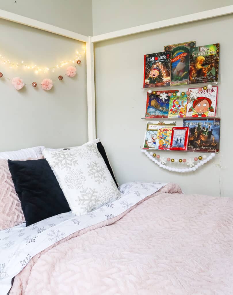 girls bedroom with Christmas book wall