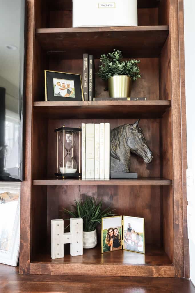 personal items on a bookshelf to make your home feel cozy