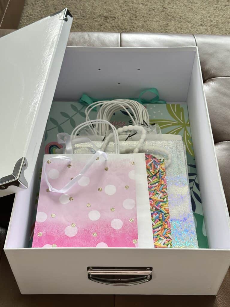 store gift bags in a stylish box under the bed